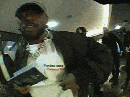 A Man Wearing A Shirt That Says Karline Rose GIF