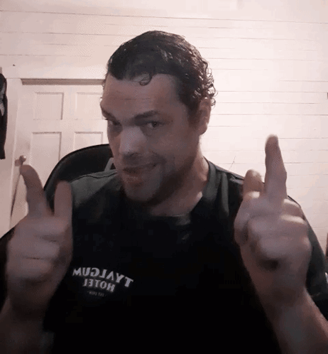 A Man Wearing A Shirt That Says Mudjayt Giving A Thumbs Up GIF