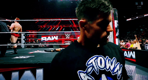 a man wearing a shirt that says raw on it