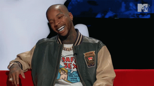 A Man Wearing A Shirt That Says Saf Sex Is Smiling GIF