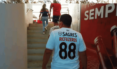 A Man Wearing A Shirt That Says Sagres Riccazeres GIF