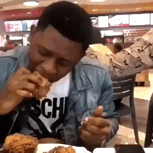 A Man Wearing A Shirt That Says Sch On It Is Eating Fried Chicken GIF