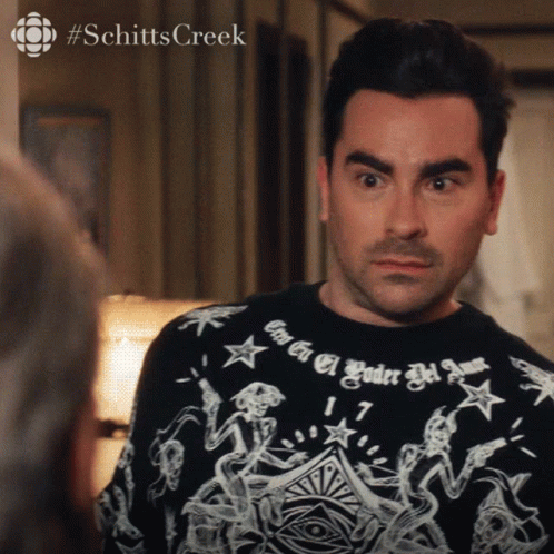 A Man Wearing A Shirt That Says #Schitts Creek GIF