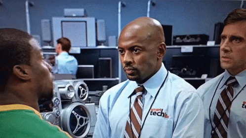 A Man Wearing A Shirt That Says Smart Tech Is Talking To Another Man GIF