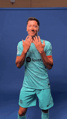 A Man Wearing A Shirt That Says Spotify Is Dancing GIF
