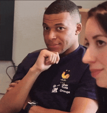 A Man Wearing A Shirt That Says Uber Eats Orange Is Sitting Next To A Woman GIF