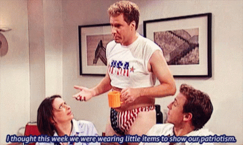 A Man Wearing A Shirt That Says Usa Is Talking To Two Other People GIF