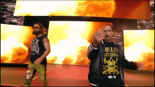 a man wearing a shirt that says valley club stands next to another man