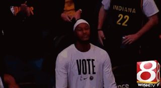 A Man Wearing A Shirt That Says Vote GIF