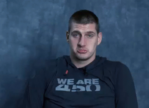 A Man Wearing A Shirt That Says We Are Zoo Is Making A Funny Face With His Hands . GIF