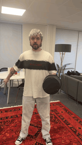 A Man Wearing A Shirt That Says You Died Holds A Black Object GIF