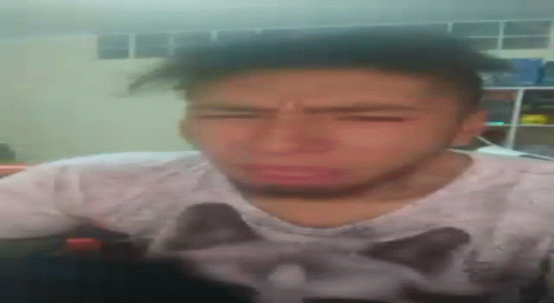 A Man Wearing A Shirt With A Cat On It Is Making A Funny Face GIF