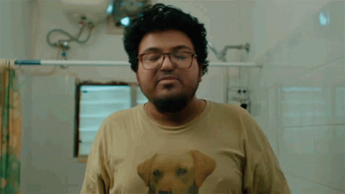 A Man Wearing A Shirt With A Dog On It Is Washing His Hands GIF