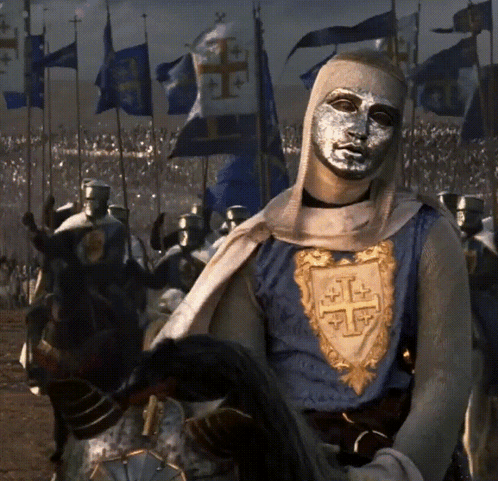Man With Silver Mask Riding Horse In Front Of Soldiers GIF