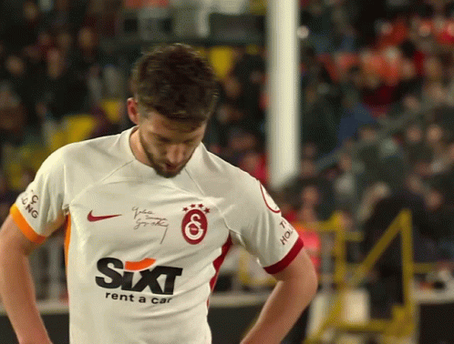 A Man Wearing A Sixt Rent A Car Jersey Looks Down GIF