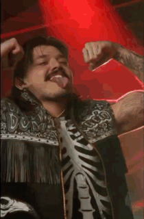 A Man Wearing A Skeleton Shirt Is Dancing In A Dark Room GIF