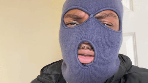 A Man Wearing A Ski Mask With A Hole In His Mouth GIF