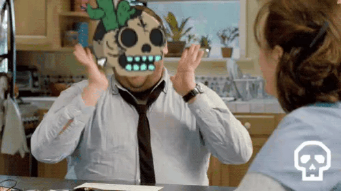 A Man Wearing A Skull Mask Is Talking To A Woman In A Kitchen . GIF