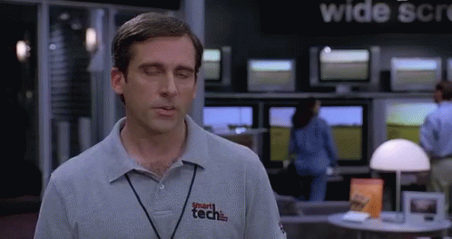 A Man Wearing A Smart Tech Shirt Stands In Front Of A Wide Screen Tv GIF