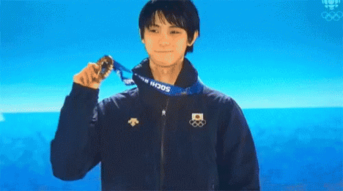 A Man Wearing A Sochi Jacket Holds A Medal Around His Neck GIF