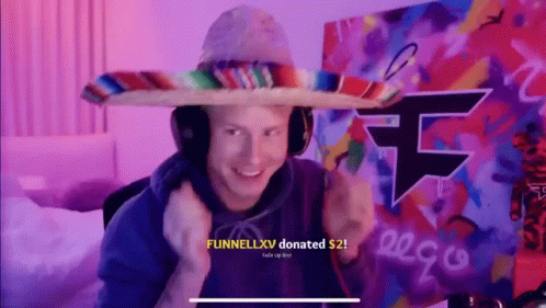 A Man Wearing A Sombrero And Headphones Is Giving A Thumbs Up In Front Of A Graffiti Wall . GIF