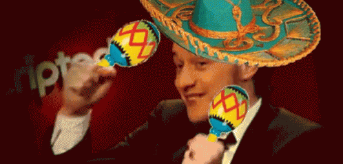 A Man Wearing A Sombrero Is Holding Maracas In Front Of A Red Background GIF