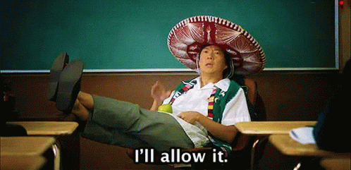 A Man Wearing A Sombrero Sits In A Classroom With The Words " I 'Ll Allow It " Below Him GIF