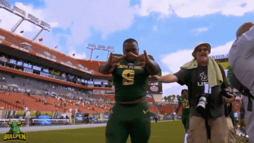 A Man Wearing A South Florida Jersey Stands On A Football Field GIF