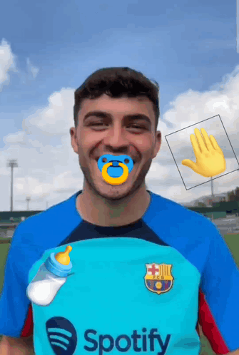 a man wearing a spotify shirt with a pacifier and a bottle