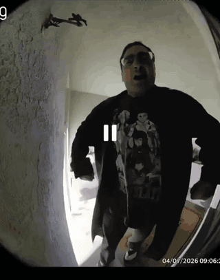 A Man Wearing A Star Wars Shirt Is Standing In A Room GIF