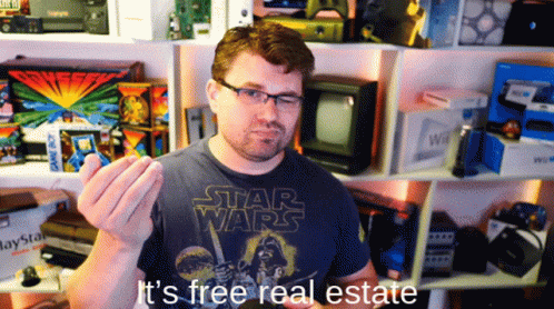 A Man Wearing A Star Wars T-Shirt Is Holding Something In His Hand GIF