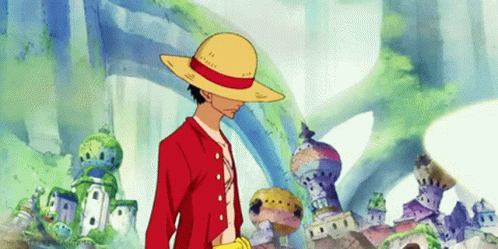 A Man Wearing A Straw Hat And A Red Jacket Is Standing In Front Of A Building . GIF