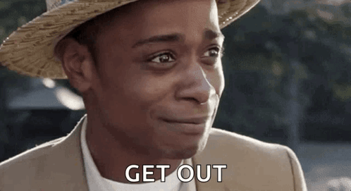 A Man Wearing A Straw Hat And A Suit Is Smiling And Saying `` Get Out '' . GIF