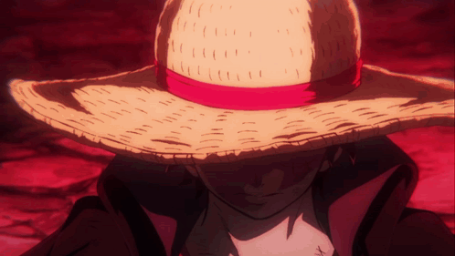 A Man Wearing A Straw Hat With A Red Ribbon Around It GIF