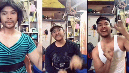 a man wearing a striped shirt and a white tank top makes a funny face