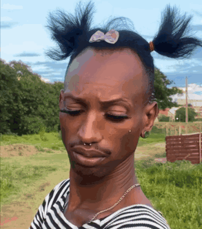 A Man Wearing A Striped Shirt With Pigtails On His Head GIF