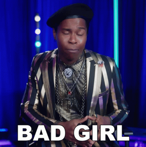 A Man Wearing A Striped Suit And A Black Hat Says Bad Girl GIF
