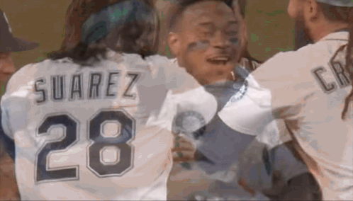 a man wearing a suarez 28 jersey is hugging another man