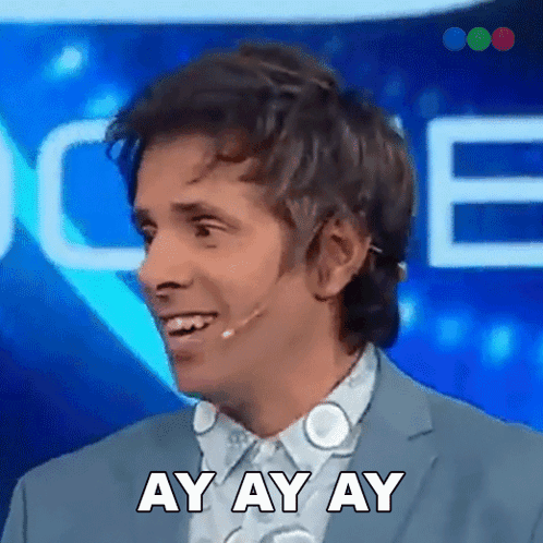 A Man Wearing A Suit And A Microphone Is Smiling And Saying Ay Ay Ay GIF