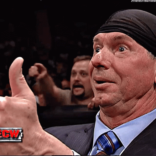 A Man Wearing A Suit And Tie Is Giving A Thumbs Up GIF