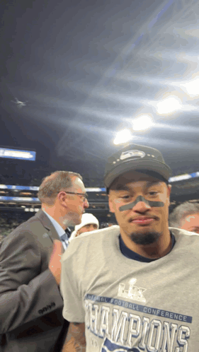 a man wearing a super bowl champions t-shirt