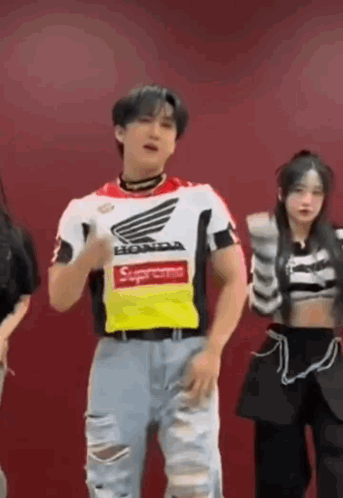 A Man Wearing A Supreme Shirt Is Dancing With A Group Of People . GIF