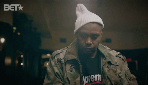 A Man Wearing A Supreme T-Shirt And A White Beanie GIF