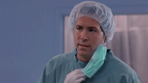 A Man Wearing A Surgical Gown And A Mask Says But Why GIF