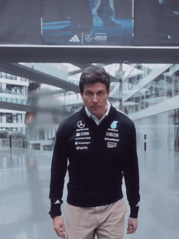 A Man Wearing A Sweater That Says Ineos On The Front GIF