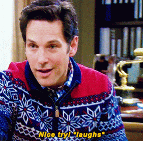 A Man Wearing A Sweater That Says Nice Try Laughs On It GIF