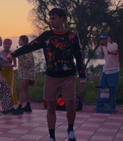 A Man Wearing A Sweater With A Superhero On It GIF