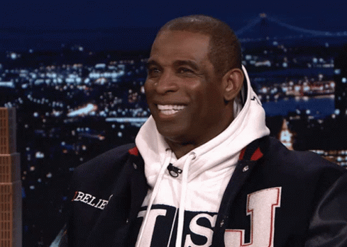 A Man Wearing A Sweatshirt That Says Believe On It GIF