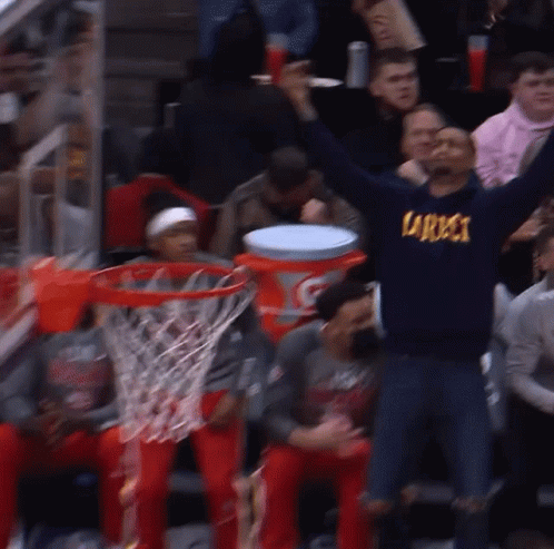A Man Wearing A Sweatshirt That Says Specs Is Raising His Arms In The Air GIF