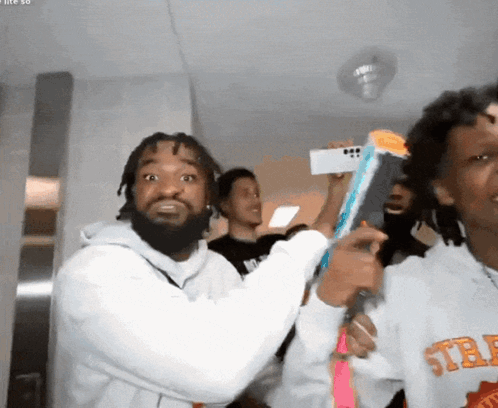 A Man Wearing A Sweatshirt That Says ' Std ' On The Front GIF